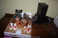 Overview photo showing all items in the lot: four ceramic chicken salt and pepper shakers, two copper mugs, metal elephant bookends, and wooden bookends.