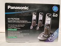 Front box photo displaying Panasonic brand and model KX-TG7533C. Shows three cordless handsets and main answering system base station with illuminated LCD screens.
