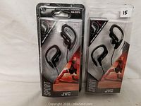 Two sealed retail packages each containing JVC HA-EB75 sport stereo headphones, both labeled 'Sport' with image of a runner on packaging.