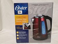 Box of Oster stainless steel cordless electric kettle in red with 1.7 liter / 7 cup capacity shown with branding and features.
