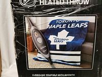 Front view of official NHL Toronto Maple Leafs heated throw packaging showing blanket and controller image