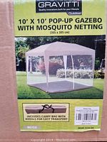 Front label of the box showing the brand Gravitti and product details: 10 ft x 10 ft pop-up gazebo with mosquito netting. Shows image of erected beige gazebo outdoors.