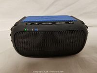 Front view of Ecorox Bluetooth speaker showing speaker grille and status LEDs lit.