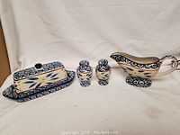 Full view of the Temp-tations dinner table completer set including butter dish, salt and pepper shakers, and gravy boat arranged on a white backdrop.