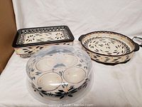 Seven-piece set including multiple ceramic baking dishes with Old World floral pattern and a metal oven rack.