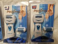 Single Pedi Smooth callous remover packaged with additional exfoliating head in sealed blister pack with blue background.