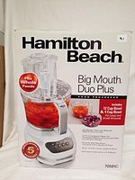 Front view of the Hamilton Beach Big Mouth Duo Plus food processor box featuring the appliance image and key features.