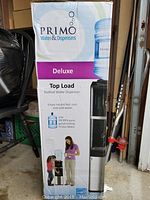 Box of the Primo Deluxe Top Load Bottled Water Dispenser showing branding and product image