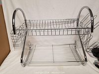 Front view of two-tier chrome dish rack with utensil holder and plastic drain tray on bottom tier