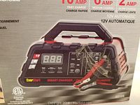 Close-up photo of the Everstart Smart Charger front control panel with digital display and charging clamps visible.