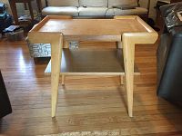 Front and side view of mid century modern oak end table showing overall design and legs.