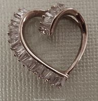 Front view of gold-washed 925 sterling silver heart pendant featuring clear cubic zirconia baguette stones along one side, showing detail and condition.