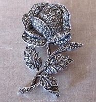 Front view of the vintage rose and leaves brooch showing detailed marcasite stone setting and rhodium plated metal.
