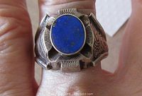 Front view of ring showing oval lapis lazuli stone and silver engraved band