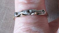 Front view of the vintage etched band ring showing three stone holes and the mixed white and yellow gold metals.