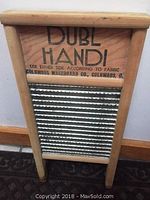 Front side of double sided washboard showing 'DUBL HAND!' label and metal scrubbing surface