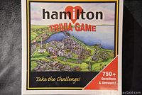 Front view of the boxed Hamilton Trivia Game featuring city artwork and text indicating 750+ questions and answers.
