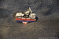 Front view of Harley Davidson enamel collectible pin showing motorcycle design and logo text