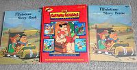 Two identical Flintstone Story Book hardcovers and a Cartoon Classics Deluxe Volume book featuring Flintstones stories.
