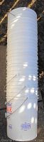 Stack of nine or ten white 20-litre plastic pails with metal handles, no lids included.