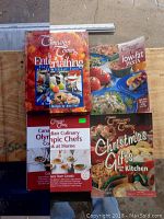 Photo of four cookbooks all by Company's Coming, including Entertaining, Low-Fat Pasta, Canadian Culinary Olympic Chefs, Christmas Gifts from the Kitchen.