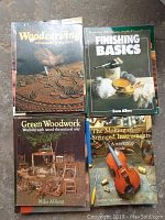 Photo of four woodworking books: Woodcarving Techniques & Projects, Finishing Basics by Sam Allen, Green Woodwork by Mike Abbott, and The Making of Stringed Instruments by George Buchan.