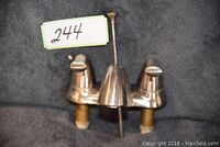 Front and side view of a nickel finish bathroom faucet showing two lever handles and a central spout with lift rod.