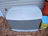 Side and top views of Rubbermaid outdoor storage container in weathered condition with hinges and locking mechanism visible.