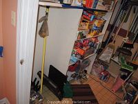 Photo of large storage shelving with various boxes of kitchen bags, plastic wrap, and household items, showing wrapped boxes and bright colored packaging.