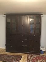 Front view showing full width with glass and solid doors above nine drawers