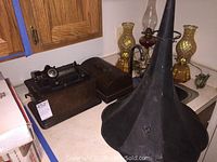 Full phonograph setup on countertop showing main unit, horn and storage box