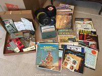 Wide view of the vinyl record collection showing assorted albums and sleeves stacked in boxes and laid out