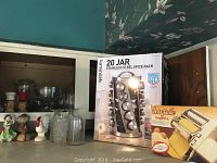 Photo of the boxed spice rack and pasta maker on kitchen counter.