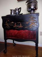 Front view of tea cart with silver service set on top