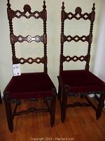 Full view of both Gothic-style high-back chairs showing wood carved backs, velvet seats, and overall condition.
