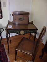Overall view of secretary desk with stationery box on top and matching cane-seat chair