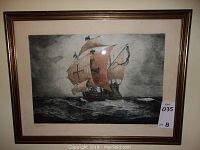 Framed art print of Santa Maria ship sailing, showing red sails and ocean waves, framed with wood-tone frame.