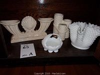 Lot of four white and beige decorative ceramic pieces, including two vases, a basket, and lidded trinket dish.