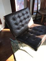 Tufted black leather Barcelona chair replica on metal frame