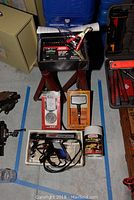 Overview of all automotive tools including battery charger, testers, timing light, and repair kit.