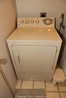 Full view of the white General Electric gas dryer with front door and control panel visible, showing overall condition and size.