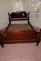 Full view of the assembled bed frame showing headboard, footboard, and side rails.