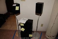 Sony home theatre speakers and subwoofer with stands on floor