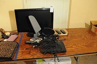 Full view of lot on table showing Samsung TV, TV antenna, Sony DVD player, remotes, and cables.