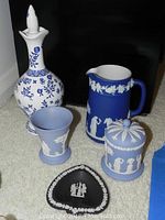 Overall view of Wedgwood Jasperware collection including decanter, pitcher, tumbler, trinket box, and black spade dish