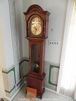 Full view of clock in room corner showing overall appearance and dimensions
