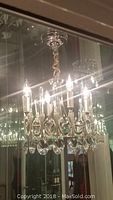 Full view of chandelier hanging from ceiling showing overall shape and crystal accents