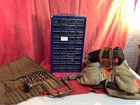 Full lot overview showing leather tool belt, metal hardware drawer unit, some drill bits and hand drills