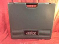 Closed gray plastic hard case labeled Emergency Roadside Kit by Restoration Hardware