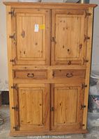 Front view of the wooden pine TV media hutch showing four doors and two drawers.